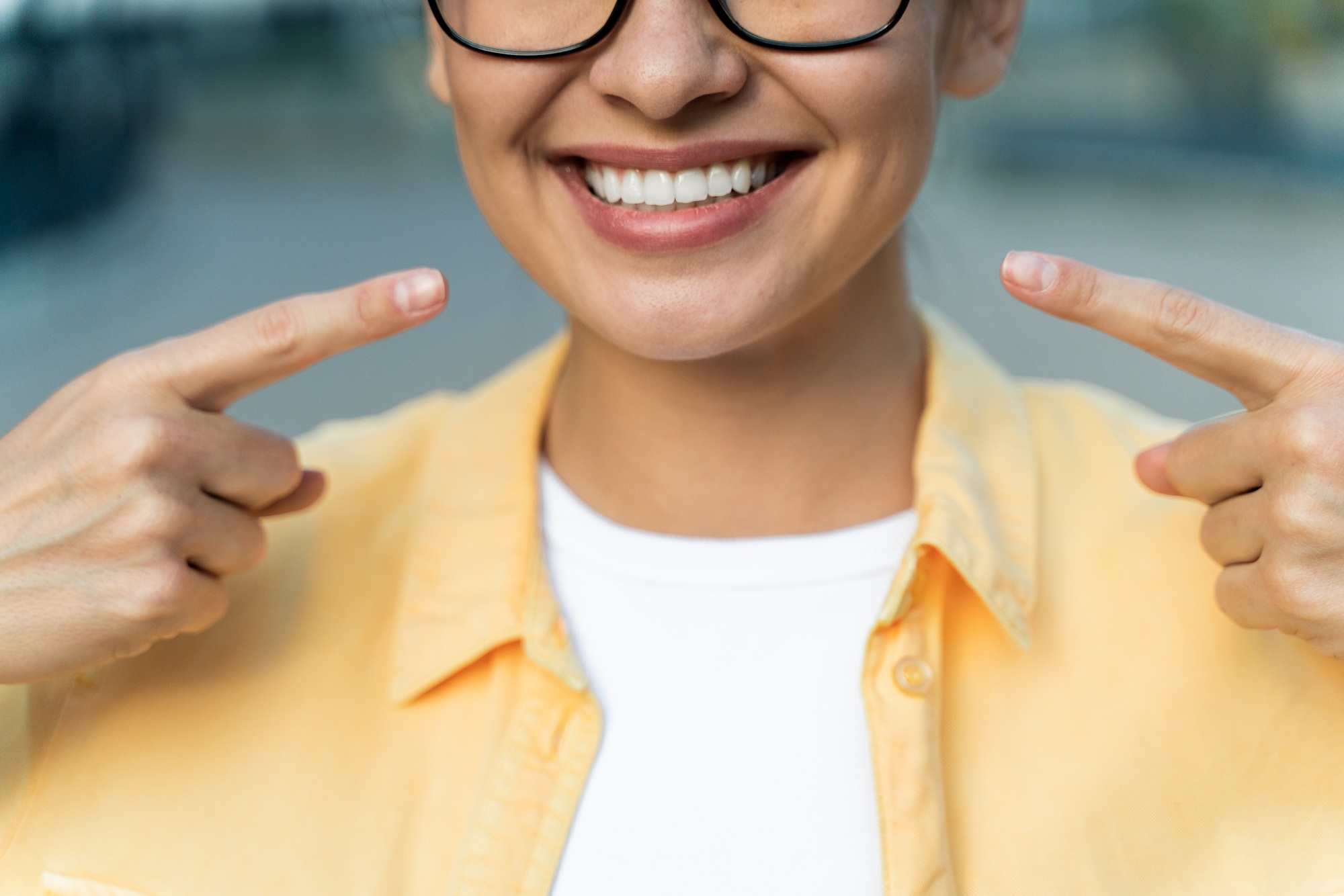 Keep smile. oman with the fingers at her smile while sharing good mood with the people. Stock photo